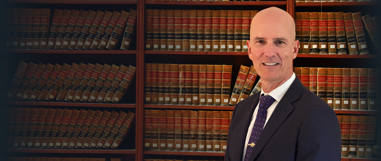 Paul J. Siegferth Jr. and a Bookcase Full of Legal Books