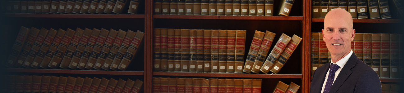 Paul J. Siegferth Jr. and a Bookcase Full of Legal Books